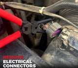 Close-up of push tab electrical connector removal pliers used in car engine repair